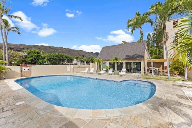 view of pool featuring a mountain view and a patio area