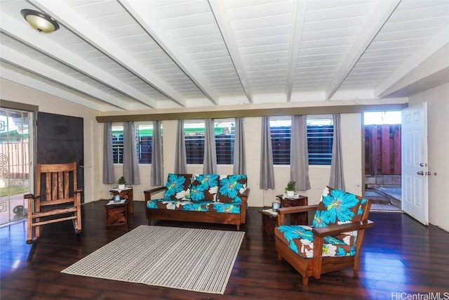 sunroom / solarium featuring vaulted ceiling with beams