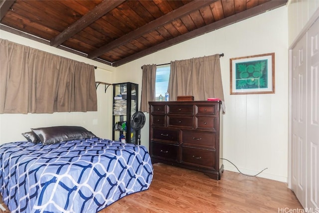 bedroom with wooden ceiling, vaulted ceiling with beams, and light hardwood / wood-style flooring