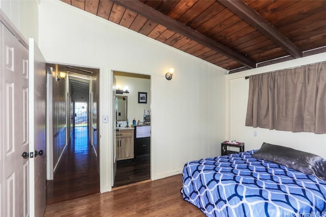 bedroom featuring beam ceiling, wood ceiling, ensuite bath, and dark hardwood / wood-style floors