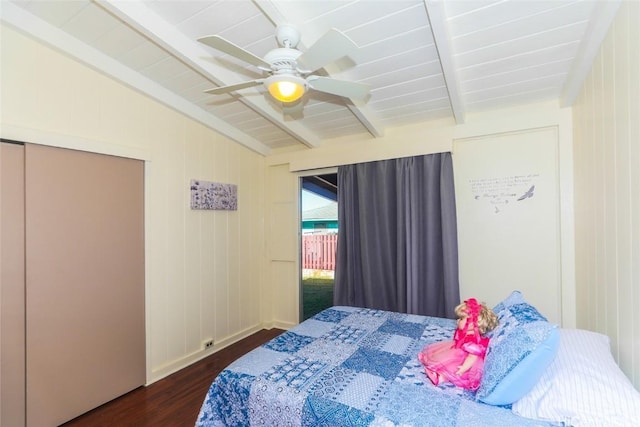 bedroom featuring ceiling fan, dark wood-type flooring, and vaulted ceiling with beams