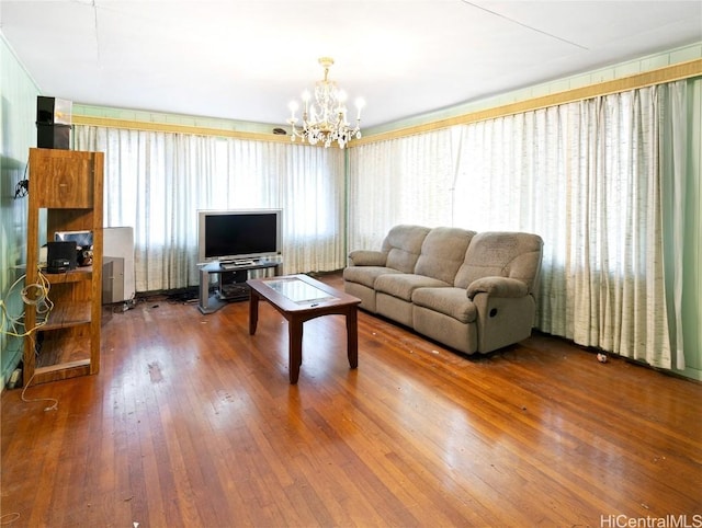 living room featuring a notable chandelier, hardwood / wood-style flooring, and a healthy amount of sunlight