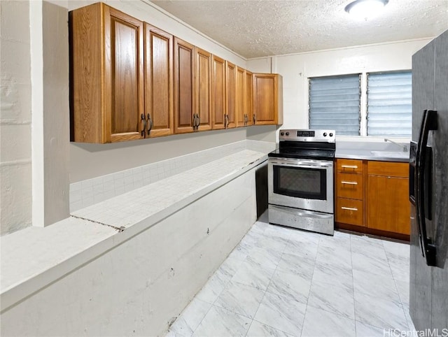 kitchen featuring sink, stainless steel electric stove, and a textured ceiling