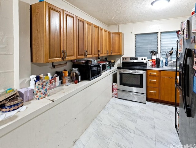 kitchen with a textured ceiling and stainless steel appliances