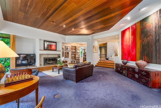 living room featuring carpet, recessed lighting, a glass covered fireplace, wooden ceiling, and stairs