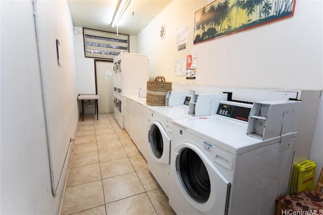 washroom with washer and dryer, stacked washer and clothes dryer, and light tile patterned floors