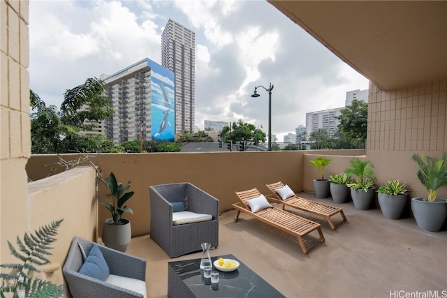 view of patio featuring a balcony