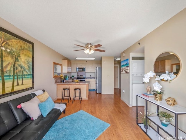 living room featuring ceiling fan and light hardwood / wood-style flooring