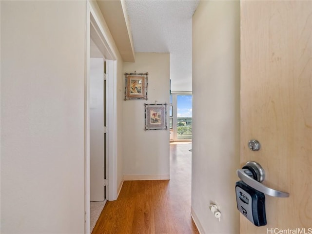 hall with hardwood / wood-style floors