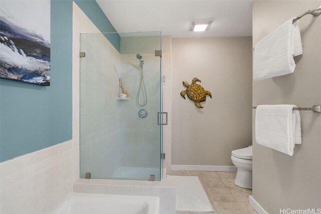 bathroom featuring tile patterned floors, toilet, and independent shower and bath