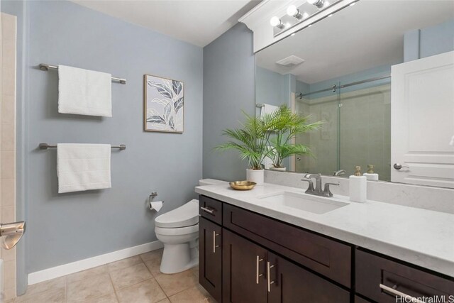 bathroom featuring an enclosed shower, vanity, tile patterned flooring, and toilet