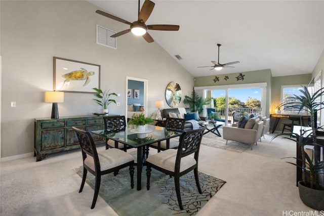 dining space featuring light carpet, high vaulted ceiling, visible vents, and baseboards