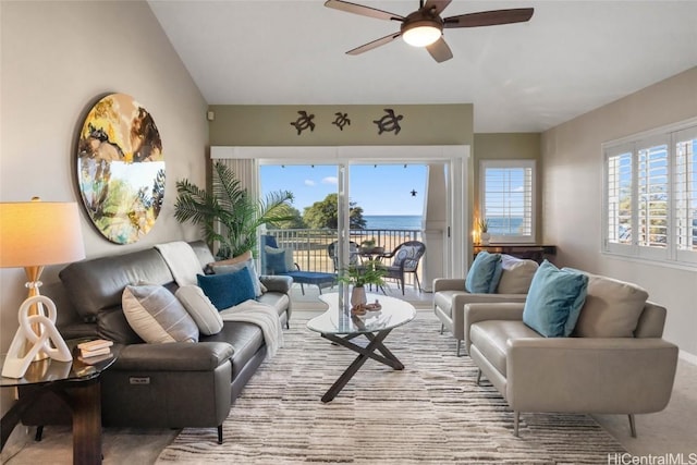 living room with a water view and ceiling fan