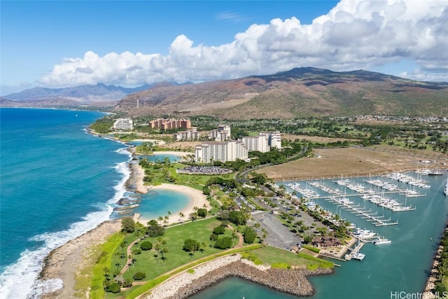 birds eye view of property featuring a water and mountain view and a beach view