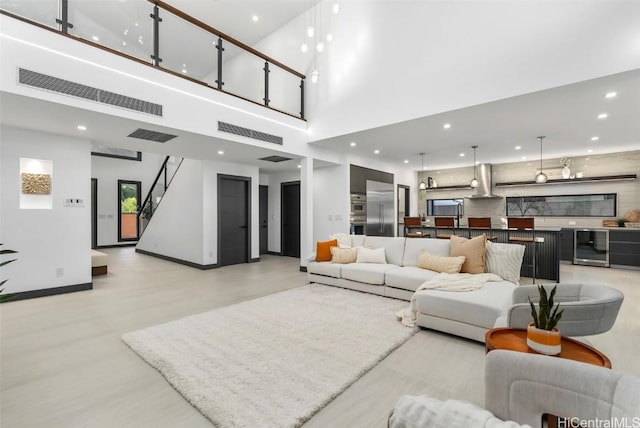 living room featuring beverage cooler and a high ceiling