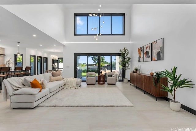 living room with a towering ceiling and french doors