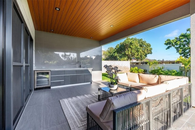 deck with a patio area, sink, an outdoor hangout area, and wine cooler