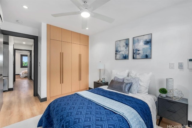 bedroom featuring ceiling fan and light hardwood / wood-style flooring