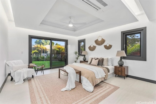 bedroom featuring a raised ceiling, access to outside, and ceiling fan