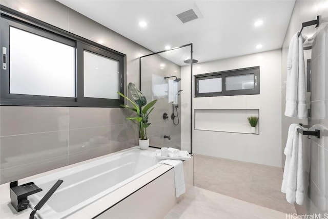 bathroom with separate shower and tub