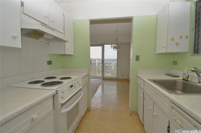 kitchen featuring white appliances, white cabinets, sink, hanging light fixtures, and a notable chandelier