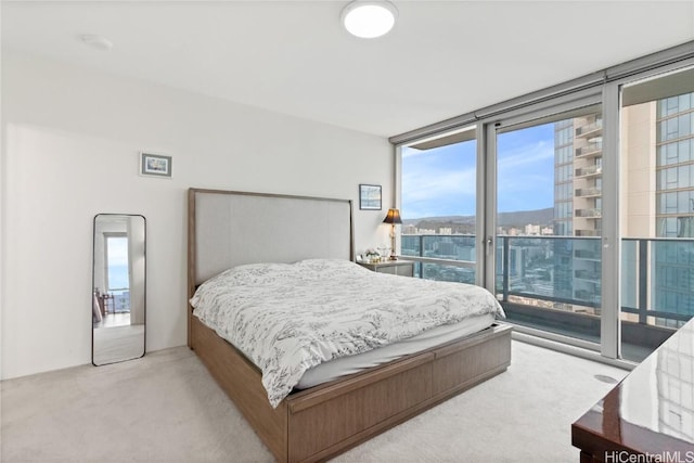 carpeted bedroom with access to exterior and floor to ceiling windows