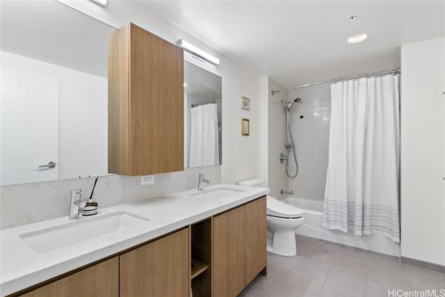 full bathroom featuring tile patterned flooring, toilet, vanity, and shower / bath combination with curtain