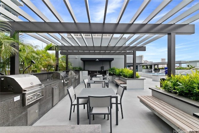 view of patio / terrace with a grill, an outdoor kitchen, and a pergola