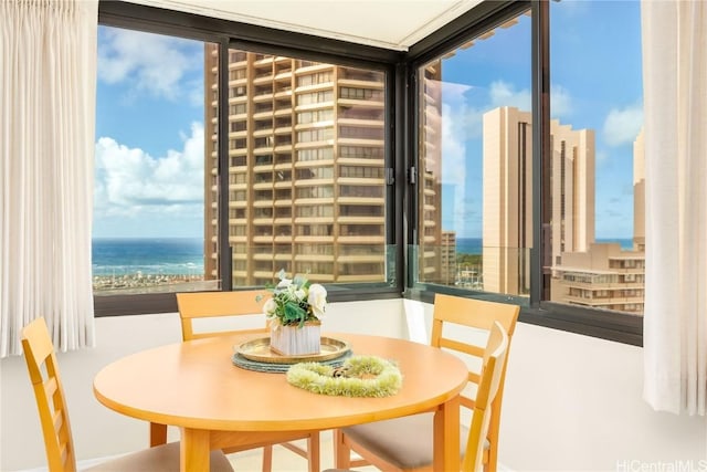 dining area featuring plenty of natural light and a water view