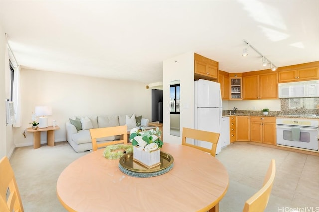 dining room with sink and track lighting