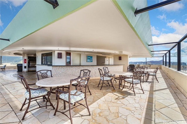 view of patio / terrace featuring a lanai