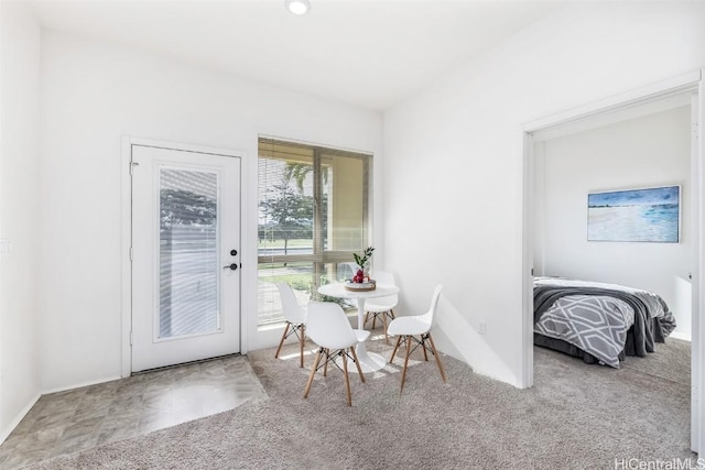 carpeted dining room featuring plenty of natural light