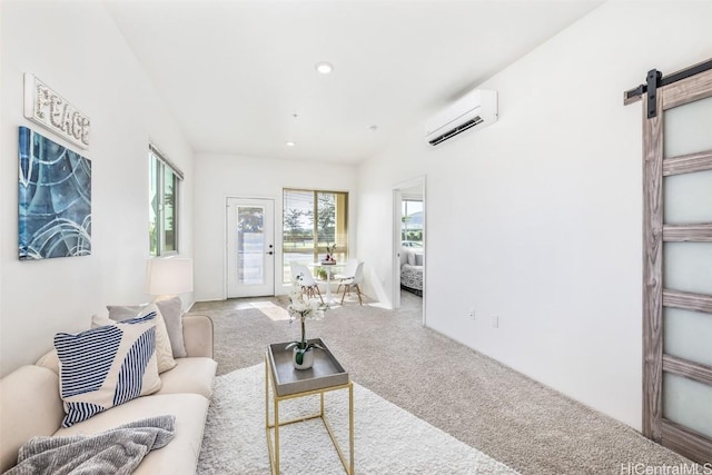 carpeted living room featuring a barn door, a healthy amount of sunlight, and a wall mounted air conditioner