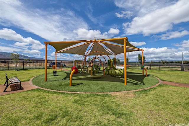 view of jungle gym with a mountain view and a lawn