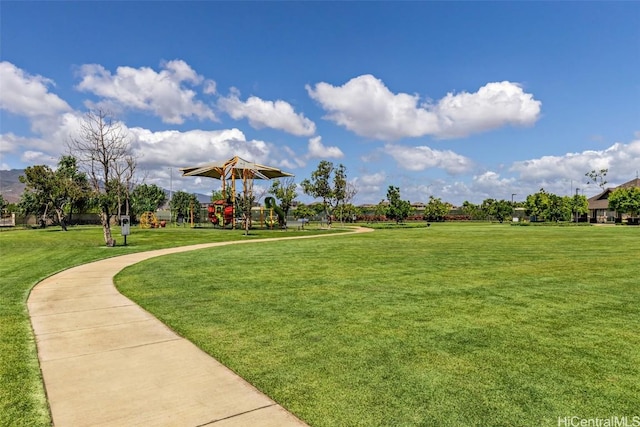 view of home's community featuring a playground and a lawn