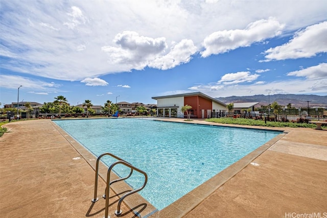 view of swimming pool with a mountain view and a patio area