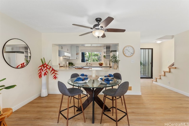 dining room featuring ceiling fan and light hardwood / wood-style flooring