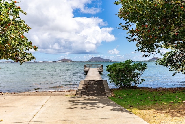 view of dock with a water and mountain view