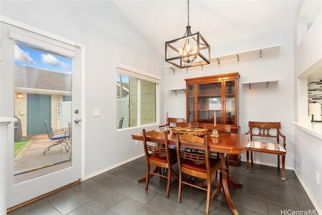 dining area featuring lofted ceiling, track lighting, and a chandelier