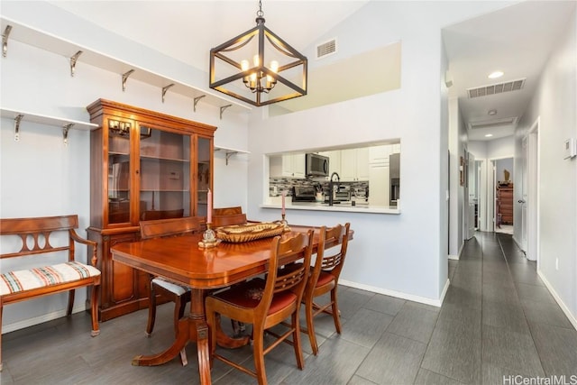 dining area with lofted ceiling and a chandelier