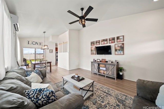 living room with vaulted ceiling, ceiling fan, and hardwood / wood-style floors