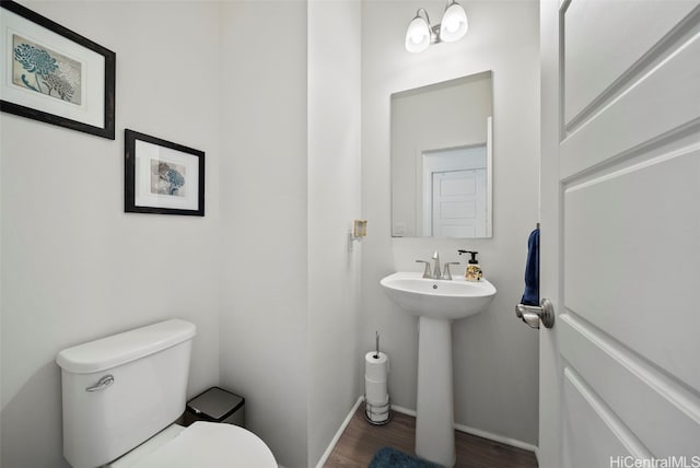 bathroom with hardwood / wood-style flooring, sink, and toilet