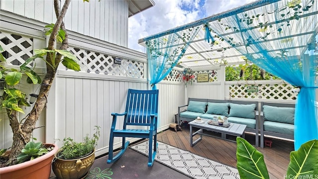 wooden deck featuring a pergola and outdoor lounge area