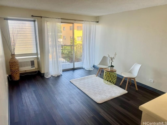 sitting room with cooling unit and dark hardwood / wood-style flooring