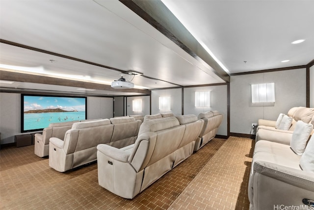 home theater room featuring ornamental molding and beam ceiling