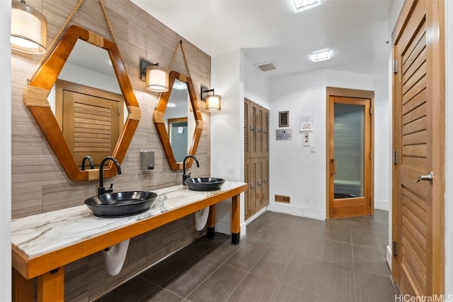 bathroom featuring sink, tile patterned floors, and decorative backsplash