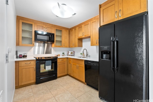 kitchen with light tile patterned floors, sink, and black appliances