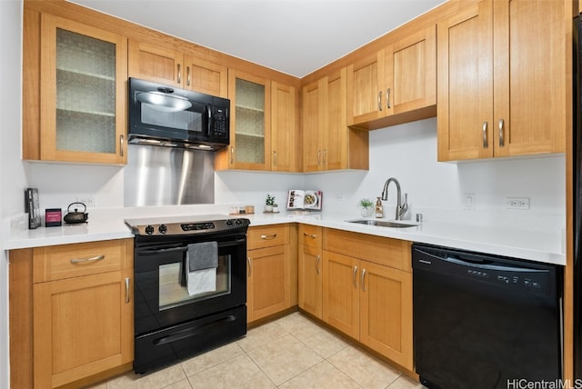 kitchen featuring light tile patterned flooring, sink, and black appliances