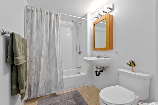 full bathroom featuring sink, tile patterned floors, shower / bath combination with curtain, and toilet