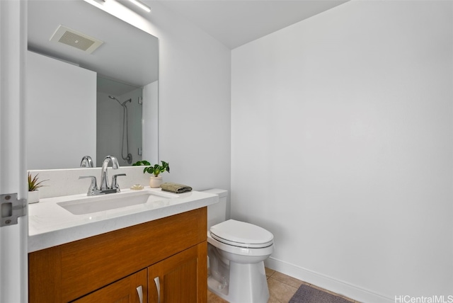 bathroom with vanity, toilet, tile patterned floors, and walk in shower